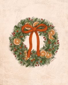 a christmas wreath with oranges and holly