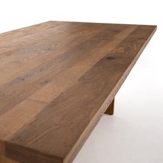 a wooden table that is made out of wood and has no one sitting at it