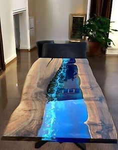 the table is made out of wood and has blue water running down it's side