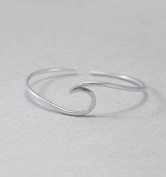 Wave cuff bangle, sterling silver, beach jewellery, ocean, beach bracelet, minimalist, adjustable, gift for her, one size Sterling silver solid cuff hand formed to a wave shape from 12 gauge (2 mm) wire. Comfortable to wear all day or sleep with and sturdy. This bangle is slightly adjustable and thus one size. It will fit most wrists (14 -18 cm / 5.5 - 7 inches wrist). But you can always ask for a different size. The bracelet above is not the exact one you will receive. Each one is handmade to o Adjustable Silver Bracelets With Ocean-inspired Style, Adjustable Silver Bracelet With Ocean-inspired Style, Adjustable Silver Ocean-inspired Bracelets, Silver Adjustable Ocean-inspired Bracelets, Silver Minimalist Bracelets For The Beach, Adjustable Ocean-inspired Jewelry For Everyday, Everyday Adjustable Ocean-inspired Jewelry, Adjustable Ocean-inspired Everyday Jewelry, Simple Adjustable Bracelet Bangle