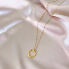 Our signature gold circle necklace is designed for layering over any necklace in our collection. Handmade, tarnish resistant 14k gold plated chain. Adjustable between 16"-18". Minimalist Circle Chain Necklace With Adjustable Chain, Minimalist Circular Chain Necklace With Adjustable Chain, Minimalist Gold Open Circle Jewelry, Minimalist Open Circle Gold Jewelry, Everyday Circular Cable Chain Necklace, Gold Necklaces With Delicate Open Circle Chain, Gold Minimalist Open Circle Necklace, Minimalist Circle Cable Chain Jewelry, Minimalist Gold Open Circle Necklace