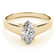 a yellow gold engagement ring with a pear shaped diamond