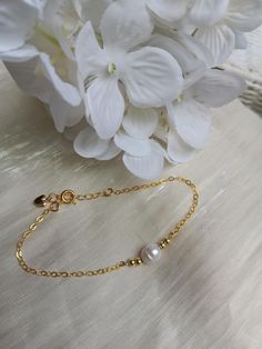 A gorgeous and dainty pearl bracelet.   A classic fresh water pearl sits between tiny gold plated beads, attached to a shiny gold plated over sterling silver (excellent quality) chain. Fits most women's wrist with a length starting at  6.5 and extender going up to 7.5". Dainty Yellow Gold Beaded Bracelets In 14k Gold Filled, Handmade Elegant Gold-plated Beaded Bracelets, Handmade Gold-plated Elegant Beaded Bracelet, Elegant Handmade Gold-plated Beaded Bracelets, Gold Plated Pearl Bracelet With Adjustable Chain As Gift, Elegant Handmade Gold-plated Beaded Bracelet, Delicate 14k Gold-filled Chain Bracelet, Dainty Pearl Charm Beaded Bracelets, Dainty Gold-plated Pearl Bracelet With Adjustable Chain