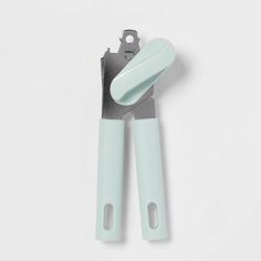 a pair of mint green handled scissors on a white background with clippings for handles