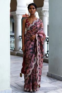 Rosewood pink saree with intricate hand painted kalamkari floral patterns, signature thread and mirror work border. Paired with silk embroidered bralette blouse.
Component: 2
Pattern: Hand Painted, Embroidered
Type Of Work: Kalamkari, Floral Patterns
Neckline: V-Neck
Sleeve Type: Sleeveless
Fabric: Silk
Color: Pink
Other Details: 
Embroidered scalloped hem saree
Embroidered blouse
Length: Saree- 5.50 Mtrs
Occasion: Wedding, Bride
Disclaimer: This product will be exclusively handcrafted, making t Archana Jaju, Long Blouse Designs, Fashionable Saree Blouse Designs, Draping Fashion, Sari Blouse Designs, Pakistani Fancy Dresses, Kalamkari Saree, Saree Designs Party Wear, Saree Models