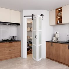 a kitchen with wooden cabinets and white walls