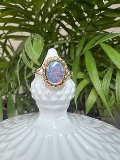 *Vintage item from 1975 *UK Size O 1/2 *Opal Triplet *9 Carat Yellow Gold  A stunning 9ct yellow gold and Opal cocktail ring. This is a striking vintage 9 Carat Yellow Gold dress ring, showcasing a gorgeous opal Triplet with a beautiful glittering display of colour, in a rubover setting with a pretty rope twist decoration.  Hallmark - This ring was hallmarked in 1975, in the UK, at the Birmingham Assay Office Stone Size -  8.8 x 6.9 mm All stones are measured by hand with a digital vernier gauge Vintage Oval Hallmarked Opal Ring, Vintage Hallmarked Oval Opal Ring, Vintage Yellow Gold Opal Ring Oval Cabochon, Vintage Yellow Gold Opal Cabochon Ring, Vintage Hallmarked Opal Ring For Anniversary, Vintage Yellow Gold Oval Cabochon Opal Ring, Vintage Opal Ring Gift, Vintage Hallmarked 14k Gold Opal Ring, Vintage 14k Gold Cabochon Opal Ring