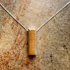 Elevate your style with our handcrafted Slim Yew Wood Pendant Necklace, a true testament to the beauty of nature and artisanal craftsmanship. Each pendant is meticulously crafted from sustainably sourced yew wood, renowned for its rich hues and distinctive grain patterns, making each piece a unique work of art. Our minimalist design features a slender yew wood pendant, expertly shaped and polished to perfection, with a nice beveled edge that adds a touch of sophistication. The beautiful wood grain of the yew wood complement the natural aesthetic, making this necklace a standout accessory. The pendant hangs delicately from a dainty yet durable sterling silver chain, measuring approximately 1.5 inches in length and 0.5 inches in width. Each necklace comes with a 16-inch sterling silver chain Artisan Natural Pendant Jewelry, Handmade Natural Jewelry For Everyday, Elegant Jewelry With Natural Variations As A Gift, Elegant Jewelry With Natural Variations For Gifts, Natural Spiritual Jewelry As A Gift, Adjustable Jewelry With Natural Variations As Gift, Natural Color Pendant Jewelry Gift, Rustic Handmade Natural Jewelry, Rustic Natural Handmade Jewelry