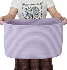 a woman holding a large purple basket in her hands