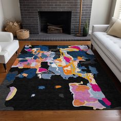 a living room with a fire place and a rug on the floor in front of it