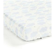 a blue and white cloud print crib sheet with stars on the bottom, in front of a white background