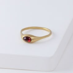 Description Hand-carved 14K yellow gold ring with a natural red garnet. Yui Ring embraces a graceful smoothness. She was made exactly for the Golden Hours - she’s confident, intelligent, poise and just entirely marvelous on her own. Not too loud, it shines just the right amount. Inspired by the nature, occasionally sweet pieces are often in organic shapes. The garnet gives a one-of-a-kind vivid red color to each ring. Details 14k Yellow GoldRed garnet - Approximately 2 x 3mm Made in U.S. *Please French Style Outfits, Handmade Gold Ring, Classic French Style, Too Loud, Nice Jewelry, Ring Stack, Garnet Jewelry, Garnet Ring, Garnet Rings