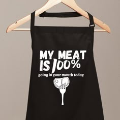 a black apron that says, my meat is 100 % going in your mouth today