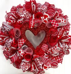 a red and white heart shaped wreath