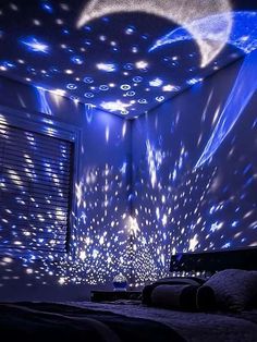 a bedroom with blue lights and stars on the ceiling, as well as a bed