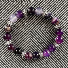 Handcrafted Grade A 10mm Purple Stripe Agate With Pewter Silver Accent Stretch Bracelet By Tang Purple Agate Has A Meaning And Properties Of Strengthening Mental Power. In The Old Days, Many Soldiers Used This Gemstone As A Good Luck Charm. They Put It On Their Breastplates And Prayed For Victory. It Would Give You The Strength To Do Things Until The End. We Only Use The Best Professional Grade Elastic Strings In Making The Bracelets For Lasting Wear And All Our Bracelets Will Never Show Any Tyi Aquamarine Bracelet Beads, Rose Quartz Bracelet Beads, Tying Knots, Jordan Shoes Retro, Shoes Retro, Purple Agate, Rose Quartz Beads, Luck Charm, Braided Leather Bracelet