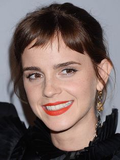 a close up of a person wearing orange lipstick