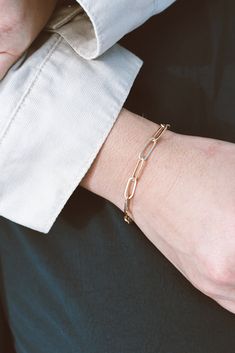 Our Paperclip Collection brings statement pieces into your everyday lineup - even if you're not a statement-jewelry-kinda-person. This beaut is lightweight & breezy while maintaining a bold presence. The Paperclip Bracelet is made from 14k Gold-Filled chain, which means you can live real life in this bracelet without fear of it turning or tarnishing. 14k Gold-Filled 7" length, one size fits most handmade in dallas, tx Hypoallergenic A tip from our team: this bracelet looks stunning paired wi Modern Chain Link Gold Bracelet, 14k Gold Filled Adjustable Paperclip Bracelet, Modern Rose Gold Chain Bracelet With Rectangular Links, Chic Oval Link Paperclip Chain Bracelet, Modern Chain Bracelet With Rectangular Links For Everyday, Dainty Paperclip Chain Jewelry For Formal Occasion, Dainty Paperclip Chain Jewelry For Formal Events, Chic Yellow Gold Paperclip Bracelet With Adjustable Chain, Minimalist Rectangular Link Jewelry Tarnish Resistant