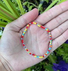 Red, yellow, and blue seed bead bracelet. Made with clear elastic cord made to fit average teen wrist. Casual Rainbow Friendship Bracelets With Tiny Beads, Colorful Casual Beaded Bracelets With Tiny Beads, Multicolor Tiny Beads Friendship Bracelets, Casual Colorful Beaded Bracelets With Tiny Beads, Casual Multicolor Tiny Beads Friendship Bracelets, Colorful Adjustable Casual Beads, Casual Rainbow Beaded Bracelets With Letter Beads, Casual Rainbow Beaded Bracelets With Tiny Beads, Red Beaded Bracelets With Letter Beads For Summer