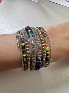 This Wrap Bracelet features colorful beads and an oxidized finish. The unique design allows for versatility in styling, adding a touch of color and texture to any outfit. Crafted with high-quality materials, it is a must-have accessory for any fashion-forward individual. One size fits all. Multicolor Spacer Beads Wrap Bangle Bracelet, Multicolor Spacer Bead Wrap Bangle Bracelet, Multicolor Spacer Beads Wrap Bracelet, Bohemian Multicolor Wrap Bracelet For Party, Colorful Beads Wrap Bracelet For Parties, Adjustable Multicolor Crystal Bracelet With Silver Beads, Trendy Colorful Beads Wrap Bracelet, Bohemian Multicolor Bracelets With Silver Beads, Multicolor Nickel-free Bracelets For Festivals