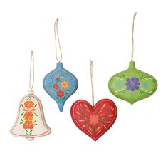 three ornaments are hanging from strings on a white background, one is shaped like a bell and the other has a flowered design