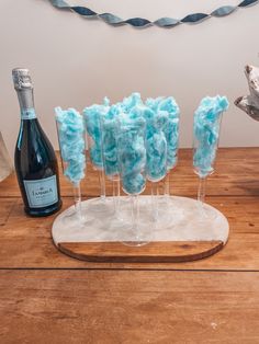 there are four wine glasses that have been made to look like blue yarn on them