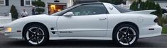 a white sports car parked in front of a house