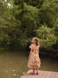 Step into a fairytale with the Garden Party Dress, where enchanting tan, pink, and green tulle layers weave a storybook dream. The sweetheart neckline and delicate flutter sleeves with charming bows make you feel like a princess, while the ruffle-tiered ankle-length skirt is perfect for twirling at any magical gathering. This dress if fit for a queen! fairytale dress, gown dresses elegant, garden party, garden dress, mommy & me dress, princess aesthetic Summer Princess Fairy Dress For Garden Party, Summer Princess Ruffle Dress, Princess Style Ruffle Dress For Summer, Summer Fairy Dress With Ruffles For Dress-up, Spring Fairy Dress With Ruffles For Dress-up, Spring Princess Dress With Ruffled Skirt, Princess Style Tiered Summer Dress, Spring Tiered Ruffle Dress For Dress-up Events, Spring Tiered Ruffle Dress For Dress-up