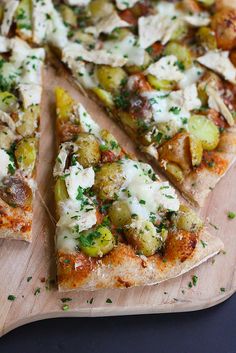 a sliced pizza on a cutting board with cheese and vegetables cut into four slices, ready to be eaten