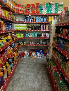 an aisle in a grocery store filled with lots of food and drink bottles on the shelves