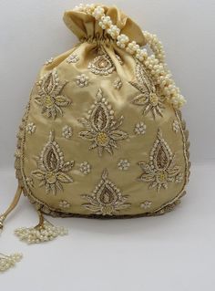 golden fabric kalash texture zardosi embroider wedding handmade handbag woman |embellish evening bag | indian potli bag purse handbagMaterial: SilkPackage Contents: As per quantity purchasedSize: 10” x 8”Designed with the heart, this beautiful Potli or batawa bag are eye catchy and made of premium material.Key Features:Embroidery art workThis potli is good match with both Indian and western outfits and are superb for wedding and festive partiesThis would be best complement to your designer saree Bollywood Style Handwork Bags For Reception, Bollywood Style Bags With Handwork For Reception, Zari Work Potli Bag For Festivals And Reception, Bollywood Style Potli Bag With Dori Work For Reception, Traditional Potli Bag With Dori Work For Reception, Festival Reception Potli Bag With Zari Work, Gold Potli Bag With Dori Work For Reception, Traditional Gota Work Bag For Reception, Gold Kundan Embroidered Fabric For Diwali