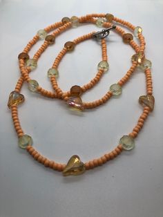 Long peach seed bead necklace made from: Matte peach 6/0 seed beads Yellow and peach crystal beads ( some heart shaped ) Necklace is 37 inches long Peach Seed, Jaune Orange, Heart Shaped Necklace, Summer Necklace, Seed Bead Necklace, Necklace Boho, Boho Necklace, Yellow Orange, Bead Necklace