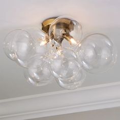 a chandelier with clear glass balls hanging from the ceiling