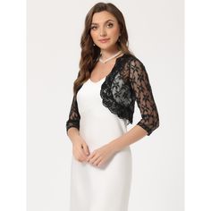 In a floral lace pattern, this stylish pretty top adds a touch of elegance to your wardrobe. This shrug is designed with floral lace, stylish gold decoration, and an open front style for a comfortable fit. Pair it with a beautiful dress or skirt for an elegant and charming look. Spring Party Lace Shrug, Spring Party Shrug With Lace Trim, Party Shrug With Lace Trim, Spring Lace Shrug With Lace Sleeves, Evening Shrug With Lace Trim, Party Lace Shrug With Lace Sleeves, Elegant Black Shrug For Spring, Elegant 3/4 Sleeve Shrug For Spring, Elegant Spring Tops With Contrast Lace