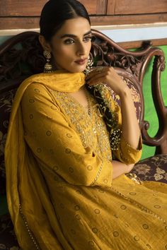 Yellow anarkali with hand embroidered yoke. Comes with churidar and crushed silk dupatta.
Component: 3
Pattern: Embroidered
Type Of Work: Floral Motifs
Neckline: V-Neck
Sleeve Type: Three Quarter
Fabric: Anarkali: Tissue Chanderi, Churidar: Lycra Net, Dupatta: Silk
Color: Yellow
Other Details: 
Floral motif embroidery
Cutwork hem lace
Note: The outfit worn by the model on the back is not for sale
Occasion: Mehendi and Haldi - Aza Fashions Yellow Anarkali, Motif Embroidery, Embroidered Anarkali, Sharara Set, Net Dupatta, Anarkali Suits, Silk Dupatta, Fashion App, Style And Grace