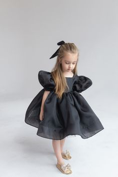 Black Organza dress Girl Baby Black girl dress First Birthday outfit Ivory Flower Girl Dress Princess dress Toddler party dress Fancy dress girl ⭐️Black Organza dress with hair bow (included)⭐️ If your little girl is having a birthday or invited to a party, this beautiful organza dress with puffy sleeves is simply essential. With this special occasion dress girls will be little fairies at any wedding, anniversary or birthday event. The black organza dress special design has been created for making your girl look really tender and awesome. ➡️To see other girl dresses https://www.etsy.com/shop/LilsBrand?ref=seller-platform-mcnav§ion_id=34367253 Size: from 6-9 months to 14 sizes Material: organza, tulle, cotton lining Making: 5-7 days Colors: black, white, ivory, blush, pink, yellow, black If Baby Black Dress Infants, Black Dress For Kids Classy, Classy Toddler Dress, Luxury Organza Tutu Dress For Summer, Childrens Black Dress, Black Party Dress For Kids, Flower Girl Black Dress, Dresses Black Kids, Princess Dresses Kids Birthday Parties