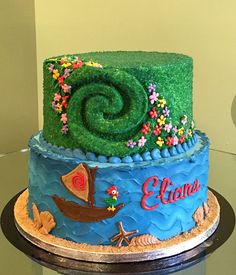 there is a cake that has been decorated with grass and flowers on the bottom layer