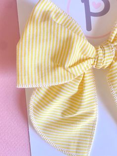 Yellow Striped Pattern  Fabric: Cotton  Sizing: - Mini: 4.5" x 4.5" - Regular: 5" x 5.5"  All items are handmade, and may contain slight variations in fabric placement. Due to different monitors and devices, colors way vary slightly. I recommend only baby or mini on nylon WARNING:  CHOKING HAZARD - Small parts Clips are not intended for children under 3 years old. It is recommended that all products should be used with adult supervision. Playful Adjustable Bow For Summer, Adjustable Playful Bow For Summer, Playful Bow Headband Hair Accessory, Cute Cotton Hair Accessories For Summer, Playful Bow Hair Accessories For Summer, Cute Cotton Summer Hair Accessories, Playful Summer Hair Accessories With Bow, Playful Summer Bow Gift, Cute Adjustable Bow For Summer