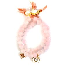 Handcrafted bracelets, AAA grade Rose quartz gemstone bracelets with pavé crystal charms finished with french silk velvet ribbon and freshwater pearls gold plated pebbled tiny rings. The blushing hue of Rose Quartz seems to snag everyone’s heartstrings. There is something about this soft and feminine crystal that oozes pure love. It comes as no surprise that the Rose Quartz meaning is that of universal love. Here is a crystal so ripe with healing properties, so drenched in harmony, and so tender Hand-wrapped Rose Quartz Bead Jewelry, Elegant Hand Wrapped Rose Quartz Jewelry, Elegant Wrap Bracelet With Natural Stones As A Gift, Elegant Wrap Bracelet With Natural Stones, Elegant Pink Hand Wrapped Jewelry, Elegant Rose Quartz Gemstone Beaded Bracelet, Elegant Rose Quartz Gemstone Beaded Bracelets, Elegant Pink Jewelry Hand Wrapped, Elegant Hand Wrapped Pink Jewelry