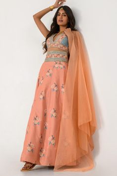 Scarlet orange and aqua green cotton rayon lehenga with floral print and sequins and zari embroidered waistband. Comes with a blouse and a dupatta.
Components: 3
Pattern: Printed, Embroidered
Type Of Work: Floral, Sequins, Zari
Neckline: V Neck
Sleeve Type: Sleeveless
Fabric: Cotton rayon
Color: Orange,Blue
Other Details: 
Closure : Lehenga - Side zip
Occasion: Party - Aza Fashions Spring Zari Work Lehenga In Traditional Drape, Spring Bollywood Lehenga With Dupatta, Summer Chanderi Lehenga With Zari Work, Summer Anarkali Lehenga With Floral Embroidery, Spring Lehenga With Dupatta In Traditional Drape, Spring Bollywood Lehenga With Traditional Drape, Spring Bollywood Choli With Dupatta, Summer Anarkali Lehenga With Resham Embroidery, Spring Designer Lehenga With Dupatta