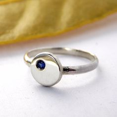 This Flat Pebble Birthstone Ring is made of sterling silver with a 2mm birthstone of your choice. This ring has been made from recycled sterling silver. It is a contemporary, modern ring perfect for any occasion. Solid Sterling Silver 2mm birthstone Face approx. 8mm across 1.3 mm thick band