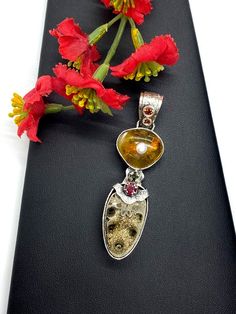 Artisan Fossil gemstone pendant  Hand-made Sterling Silver 925  Stones used: Baltic Amber, Ammonite-Fossil, Ruby, Pearl,    Garnet, Citrine  Height - 2 3/4” (with bail), Width - 3/4”Unique Handcrafted One-of a-kind Design PendantEach Piece of Jewelry in my Collection is Absolutely One of a Kind!When you start wearing a piece of my jewelry you will fall in love with it more and more each day and feel that good Energy and Love that I pass into it while creating this piece of Art.A piece of Art cre Unique Pearl Pendant Jewelry, Silver Fusion Jewelry With Pearl Pendant, Unique Pearl Pendant Jewelry Gift, Unique Pearl Pendant Necklace For Anniversary, Luxury Sterling Silver Jewelry With Natural Inclusions, Unique Teardrop Pendant Jewelry For Anniversary, Fusion Style Pearl Pendant Jewelry As Gift, Fusion Style Pearl Pendant Jewelry For Gift, Luxury Silver Jewelry With Natural Inclusions