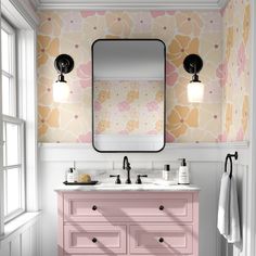 a bathroom with pink vanity and floral wallpaper