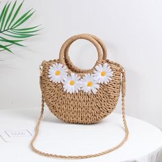 Introducing the 2023 Little Daisy Handwoven Beach Bag Step into summer with the charming 2023 Little Daisy Handwoven Beach Bag, the perfect accessory for all your sunny adventures. This beautifully crafted straw bag exudes a Bohemian vibe, making it a must-have for beach days, picnics, and casual outings. With its delightful floral appliques and half-moon shape, this bag is not just a practical accessory but a stylish statement piece that complements any summer outfit. Product Features Our 2023 Beach Tops Summer, Straw Beach Bag, Straw Handbags, Travel Summer, Top Handle Handbags, Hanging Bag, Paper Straws, Floral Applique, Vintage Handbags