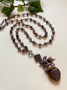 Stunning beaded pendant necklace features Czech glass florals with misty lilac pearls draping over a muted red jasper heart. The linked chain part of this beauty patterns the same lilac pearls with more Czech glass beads in shades of grape and plum and small faceted purple lace agate rondelles. Vintage finish brass wire and finding are used throughout including the graceful simple hook and loop clasp. Truly a treasure of color and bohemian style. * Measures 30” long with a 3” pendant drop * R Misty Lilac, Glass Heart Necklace, Czech Glass Necklace, Beauty Patterns, Muted Red, Necklace Amethyst, Beaded Pendant Necklace, Handcrafted Artisan Jewelry, Purple Lace