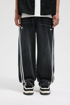 The Washed Striped Wide-Leg Pants seamlessly blend vintage style with contemporary craftsmanship. Featuring an all-over washed and distressed look, these pants are adorned with embroidered logos on each hip. The striking contrast stripes run from the back waist down the front of the legs, enhancing the body’s natural silhouette. Functional front pockets are decorated with rivets, while two back pockets provide additional utility. Crafted from premium fabric, these slightly oversized pants offer Trend Jeans, 51 Kg, Light Wash Denim Jeans, Oversized Pants, Mens Cardigan Sweater, Striped Wide Leg Pants, Cami Shirt, Varsity Jacket Men, Vest Blazer