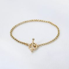 "14K GoldToggle Rolo Chain Bracelet - 14K Gold 2mm Rolo Chain Bracelet ★ 14K gold 2mm rolo chain ★ 14K gold toggle clasp ★ All components are 14K solid yellow gold The length includes the chain and the closure. Please measure your wrist before you place your order. ** How to choose a correct size of bracelet. 1. Measure your wrist below the wrist bone using a flexible tape measures, a string or a strip of paper. 2. If using a string or a strip of paper, mark length. Then, measure it with a ruler Elegant Gold Link Bracelet With Toggle Clasp, Elegant Round Chain Bracelet With Toggle Clasp, Timeless Formal Chain Bracelet With Toggle Clasp, Formal Timeless Chain Bracelet With Toggle Clasp, Classic Gold Bracelet With Toggle Clasp, Yellow Gold Plated Bracelet With Toggle Clasp, Yellow Gold-plated Bracelet With Toggle Clasp, Elegant Yellow Gold Bracelet With Toggle Clasp, Classic Yellow Gold Chain Bracelet With Toggle Clasp