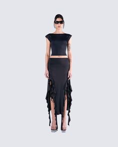 Let your sultry side shine in this sexy all-black fit 🖤 Featuring a black backless top, paired with a black ruffled maxi skirt for a look that will have you turning heads and taking names 🤤 Fitted Ruffled Crop Top For Evening, Edgy Stretch Crop Top For Evening, Chic Black Maxi Skirt For Club, Black Fitted Maxi Skirt For Club, Fitted Black Maxi Skirt For Club, Evening Stretch Maxi Skirt For Summer, Summer Evening Stretch Maxi Skirt, Elegant Black Backless Crop Top, Chic Maxi Skirt For Club In Summer