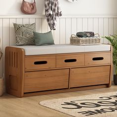 a wooden bench with two drawers underneath a coat rack and hanging hooks on the wall