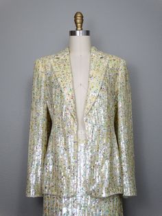 "This is a RARE and AMAZING vintage dress suit! Both pieces are beautifully detailed with sequins all over and accented with beading along the hems. It's in PERFECT condition! Note, measurements are taken with the front brought together, there are no closures on the blazer. Bust - will fit up to 38\" Shoulders - 16\" Sleeves - 24.5\" Length of Jacket - 26\" Skirt Waist - 27\" Hips - 38\" Length of Skirt - 23\" Tag Size - 4 This item comes from a pet-free and smoke-free home. If you would like mo Fitted Sequin Fabric For Spring Party, Fitted Sequin Fabric For Spring, Glamorous Embellished Sequin Fabric For Spring, Glamorous Spring Embellished Sequin Fabric, Elegant Fitted Sequin Fabric For Celebration, Glamorous Fitted Sequin Fabric For Spring, Embellished Sequin Fabric For Fall Fitted Outfits, Spring Contrast Sequin Fabric For Cocktail, Fall Embellished Fitted Sequin Fabric